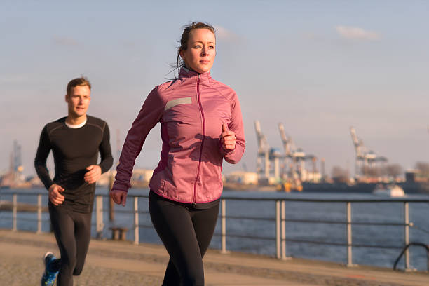 istock Young couple running on a seafront promenade 467489108