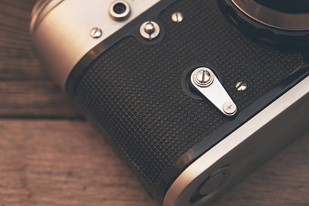 istock Vintage camera on wooden background 467491432