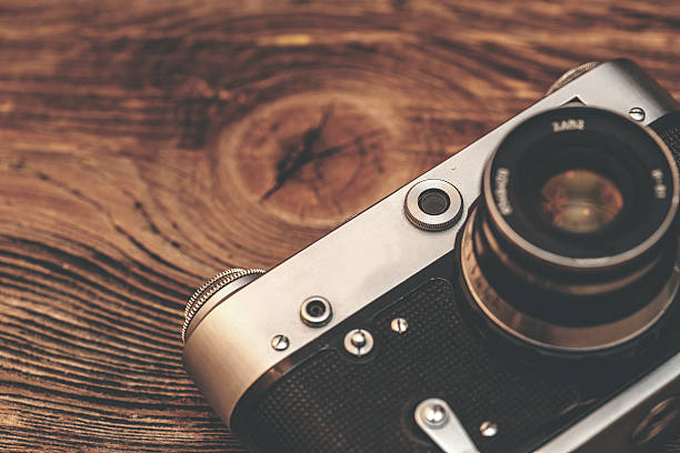 istock Vintage camera on wooden background 467491444