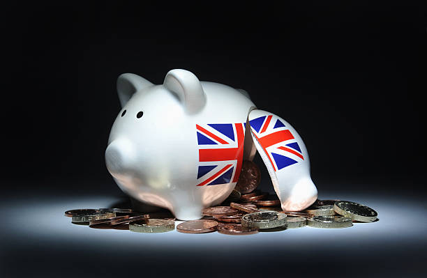 istock BROKEN PIGGY BANK SPILLING BRITISH CURRENCY UK 467496245
