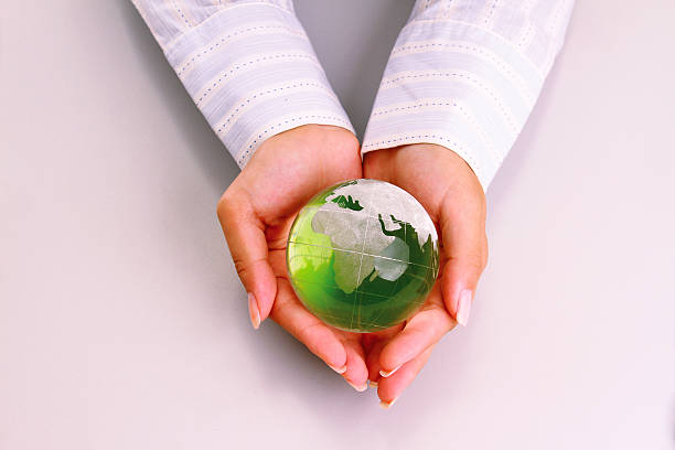 istock attractive woman holding a glass globe 467496933