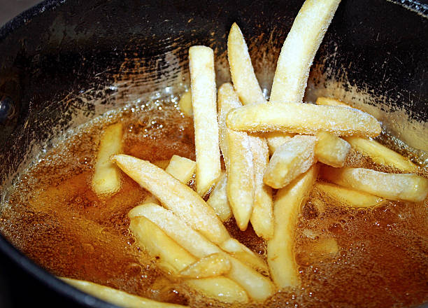 istock Frozen french fries going into a deep fryer 467498126