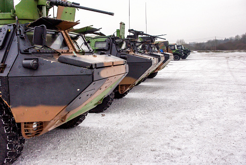 Several old military vehicles aligned , they carrying French troops. Ready to face the Ice Battle