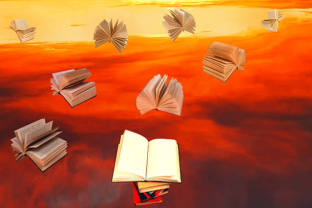 istock stack of books and red sunset sky background 467506881