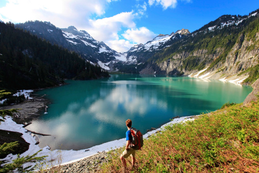 Hiker on the Blanca Lake, Washington. State. Located in the Henry M. Jackson Wilderness Area, Beautiful turquoise green lake. Only accessible by foot. Elevation Gain: 2700 ft in. 5 hours, 8 miles.