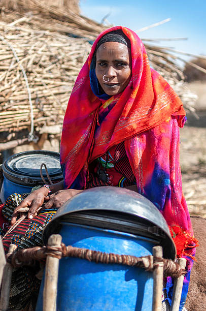 Nomad portrait Portrait of an African woman, she seated on the back of a donkey, bogus full of water on each side sudan stock pictures, royalty-free photos & images