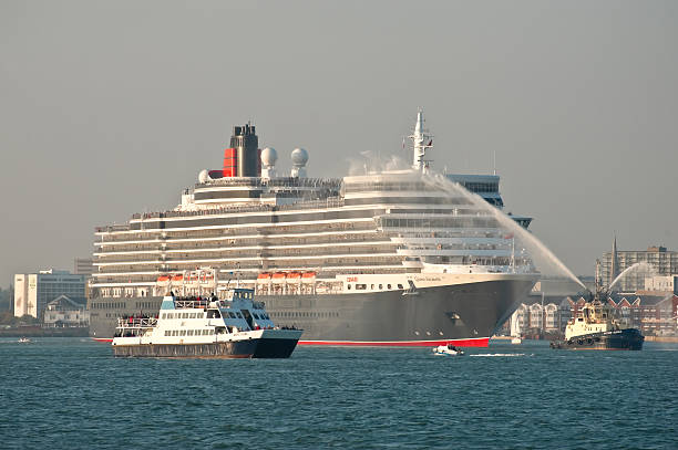 Southampton, UK - October 12, 2010: The Queen Elizabeth cruise liner departing at sunset from the UK port of Southampton on her maiden voyage. Operated by Cunard, the ship is 295 metres in length with a gross tonnage of approx. 91,000