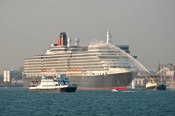 Queen Elizabeth cruise liner Southampton, UK - October 12, 2010: The Queen Elizabeth cruise liner departing at sunset from the UK port of Southampton on her maiden voyage. Operated by Cunard, the ship is 295 metres in length with a gross tonnage of approx. 91,000 southampton england photos stock pictures, royalty-free photos & images