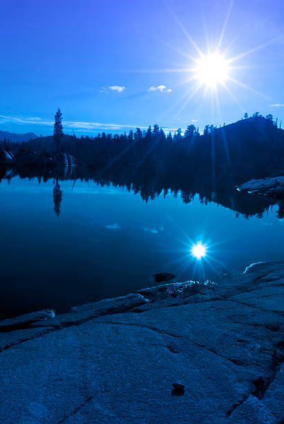 Blue Mountain Lake Reflection Blue mountain lake reflection with sun, granite, trees, Emigrant Wilderness, Stanislaus National Forest, California stanislaus national forest stock pictures, royalty-free photos & images