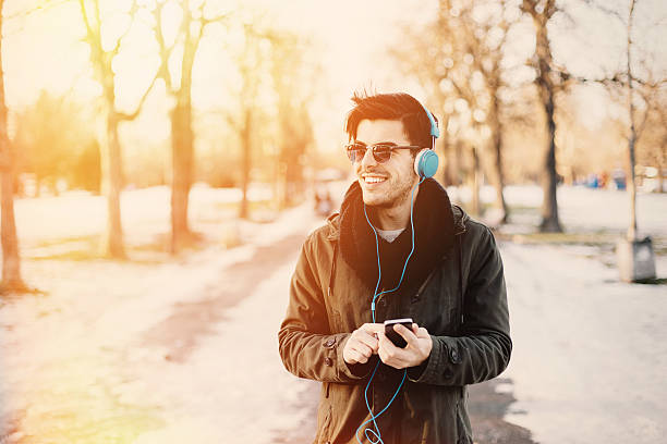 istock Man enjoying the music at the park 467511316