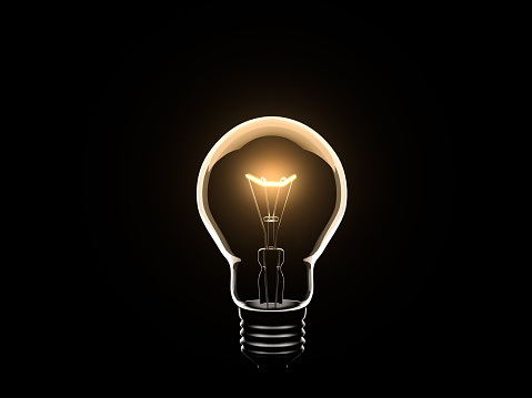 Light Bulb turned on and isolated on black background