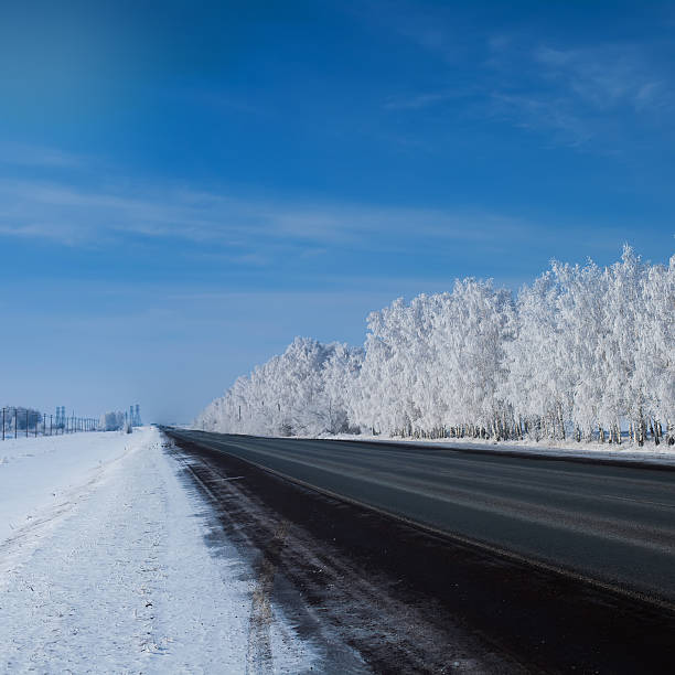istock beautiful winter landscape with road and snow-covered trees. 467512272