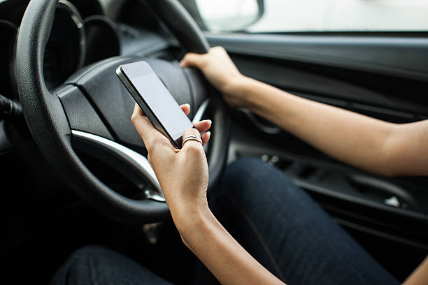 istock Close-up of a woman hand sending a text while driving 467513254