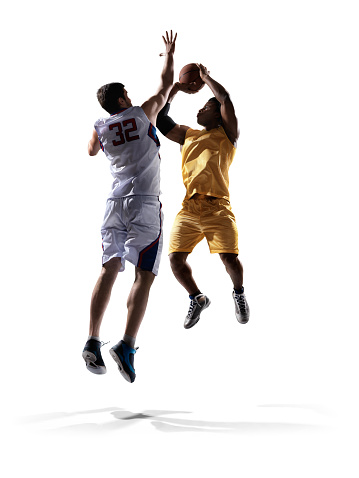 Isolated on white professional basketball players standing holding basketball