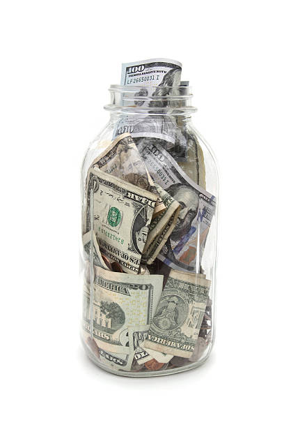 istock Large jar filled with currency and coin 467514574