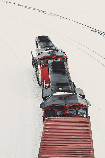 A freight train rounds a bend after a heavy snowfall.