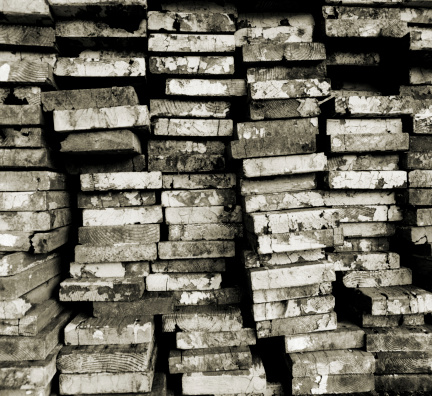 Stacks of old wooden planks shot in medium format in black and white.