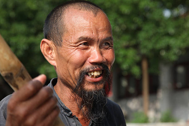Guangxi, China - June 18, 2012: Chinese man in old hat Guangxi region, traditional type of man face in China, June 18, 2012, Guangxi, China