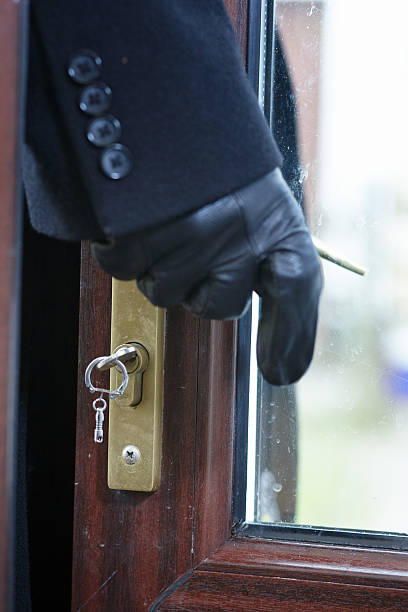 istock Opportunist thief opening patio door 467517421