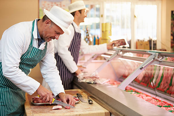 istock Two butchers in striped aprons at work 467519453