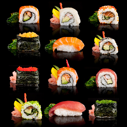 Delicious sushi, maki, nigiri pieces isolated on black background