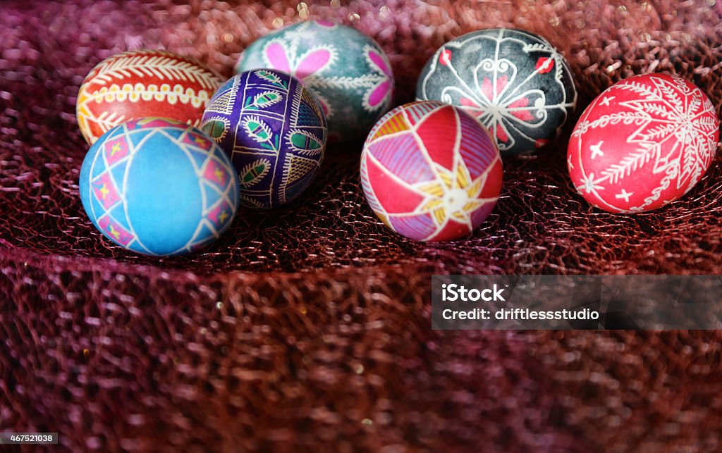 Hand painted decorated Easter eggs A grouping of beautifully hand-painted eggs on shimmering fabric 2015 Stock Photo