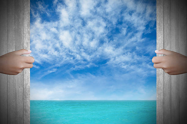 istock Two hands to open the door sea background 467524532