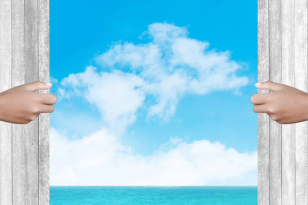 istock Two hands to open the door sea background 467524536
