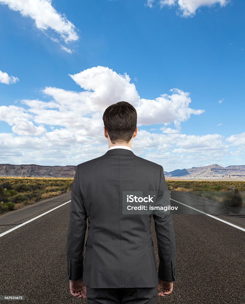 businessman on road toung businessman on road lookint into the distance 2015 Stock Photo