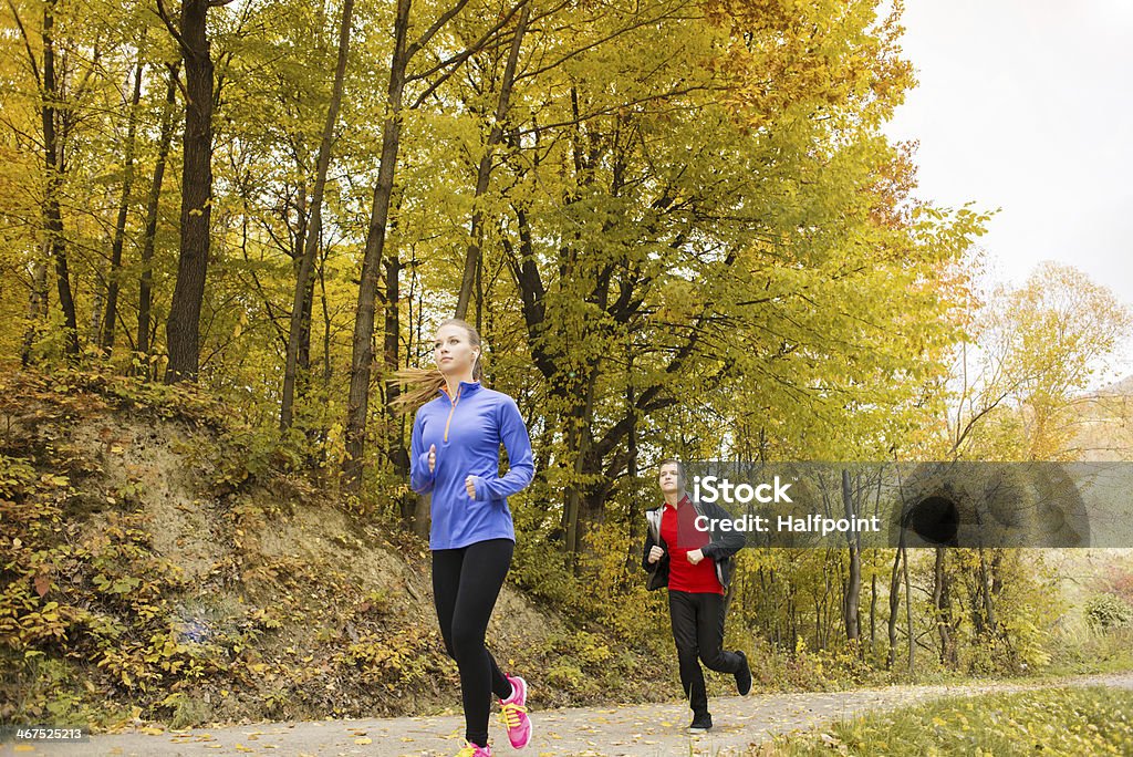 Running couple Young running couple jogging in autumn nature Active Lifestyle Stock Photo