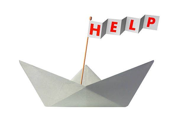 istock Origami paper boat with flag writing HELP 467525894