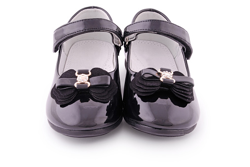 Pair of children's black patent leather shoes. Clipping path included.