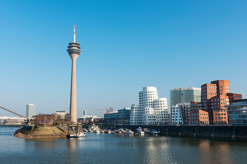 Dusseldorf's Media Harbor (Medienhafen) with Rheinturm tower and modern architecture by Frank O. Gehry.