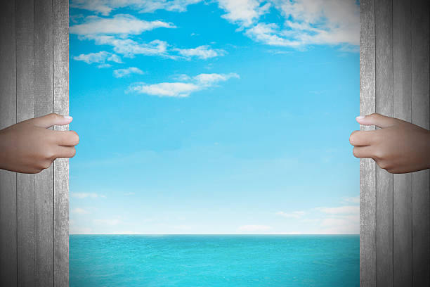 istock Two hands to open the door sea background 467527424