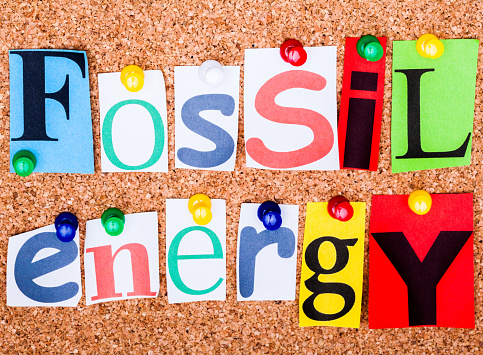 The phrase Fossil energy in cut out magazine letters pinned to a cork notice board