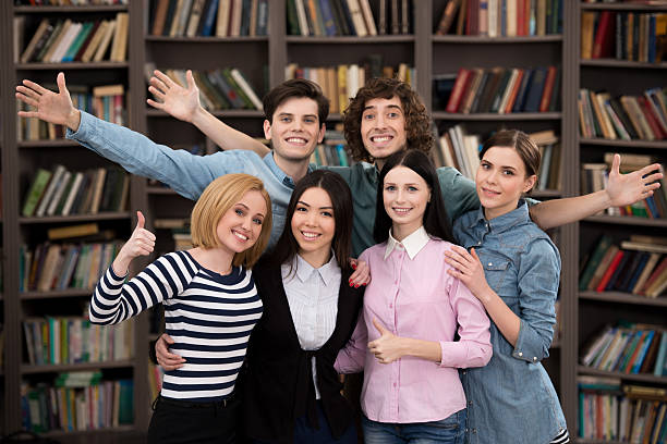 istock Business team smiling in office interior with big bookcase 467527468