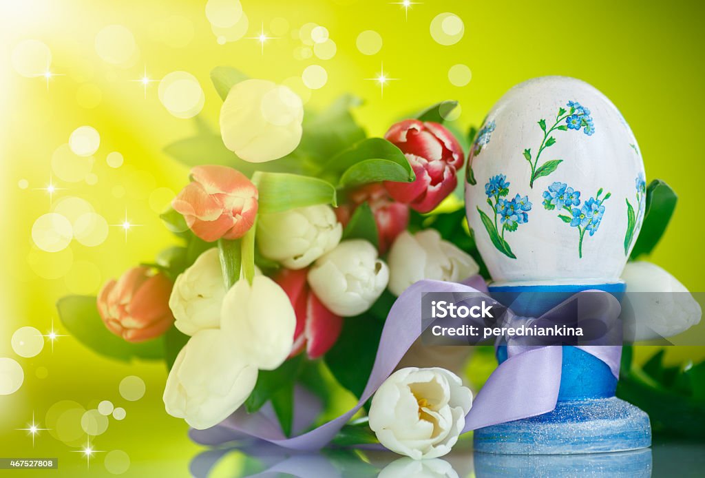 Decorative easter egg with a bouquet of spring tulips Decorative easter egg with a bouquet of spring tulips on a green background 2015 Stock Photo