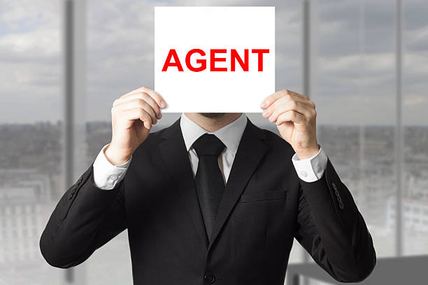 istock secret agent hiding face behind sign 467528134