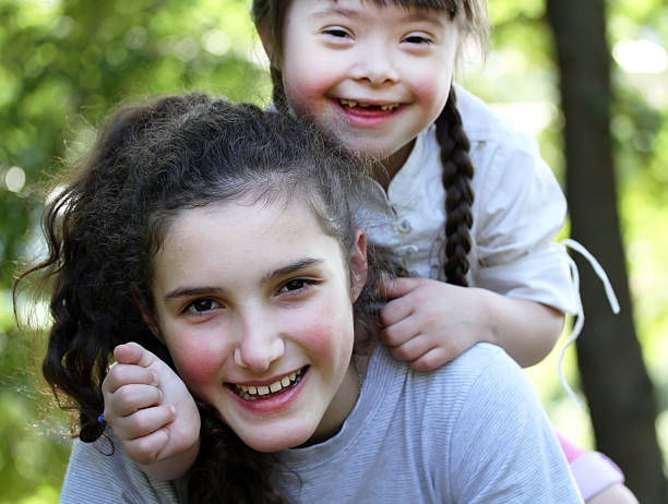 istock Happy sisters playing together outside 467528529