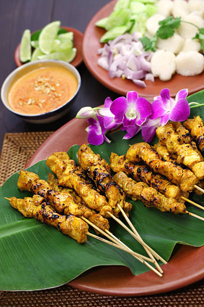 chicken satay with peanut sauce, indonesian skewer cuisine chicken satay, sate ayam and lontong with peanut sauce, indonesian skewer cuisine fresh cilantro stock pictures, royalty-free photos & images