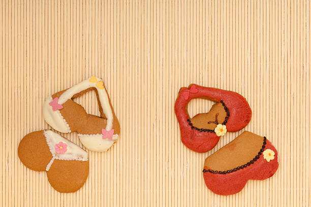 istock Funny colorful bikini shape gingerbread cakes cookies on bamboo mat 467531329