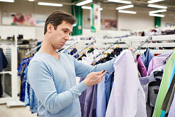 istock Surprised man looking at price tag of goods 467532868
