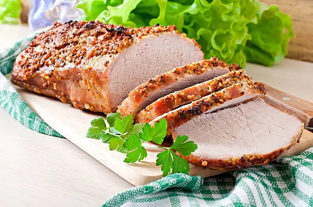 Photo of Cut pieces of baked meat on the table