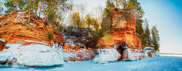 Lake Superior Shore The sea caves become covered in ice in the winter brightly lit winter season rock stock pictures, royalty-free photos & images