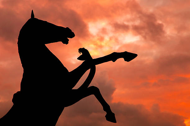 Horse and Snake monument silhouette with over cloudy red sky background