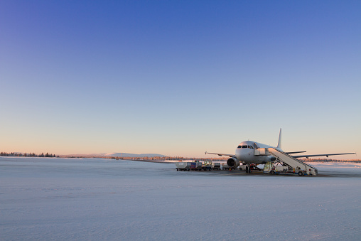 Winter vacatin concept - plane waiting for passangers in Kittila airport, Finland - gateway to Lapland