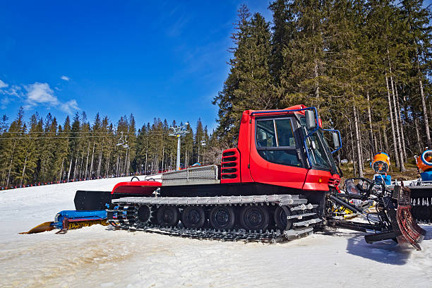 Snow plow machine in the ski slope