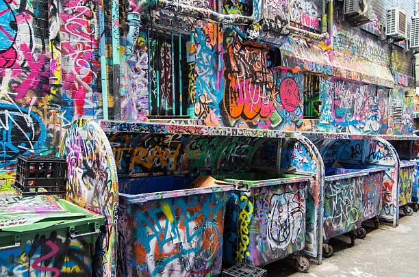 Graffiti covered rubbish bins in a laneway in Melbourne, Australia.