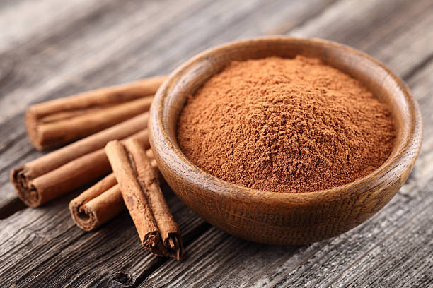 Cinnamon powder with sticks stock photo