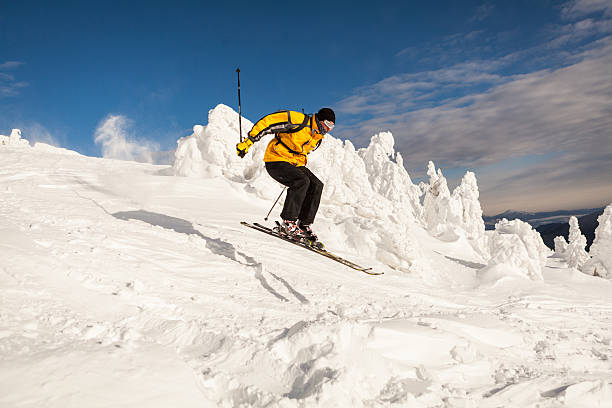Man Snow Skiing making a jump stock photo